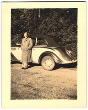 Photograph man next to his BMW 326 car 