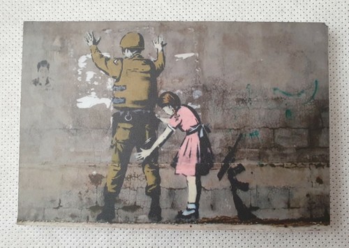 Banksy girl frisking soldier - frisking,