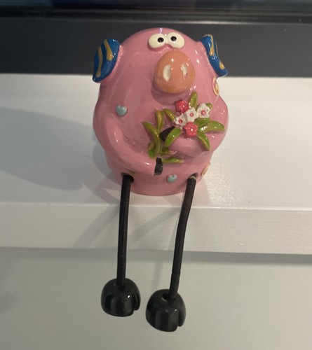 Pig with dangly legs holding - with,