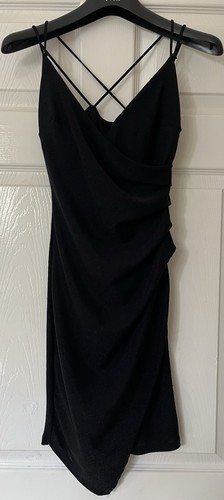 Black cocktail dress features