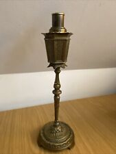 An antique brass table lighter