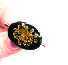 Dried flowers in resin brooch
