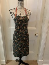 Christmas cloth apron with sparkling acorns and red ribbon. 