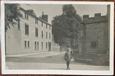RPPC YOUNG DELIVERY BOY WITH WICKER BASKET STANDING IN UNKNOWN STREET NUMBER 36