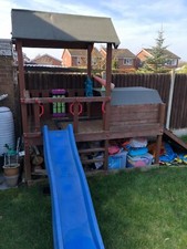 Wooden outdoor kids play area with slide used but still good condition 