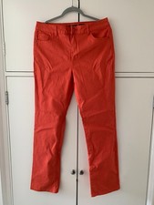 A pair of ladies orange straight leg jeans size 14