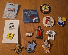 Selection of Badges, Stephensons Rocket, Aladdin, Wombles, Meg & Mog Etc