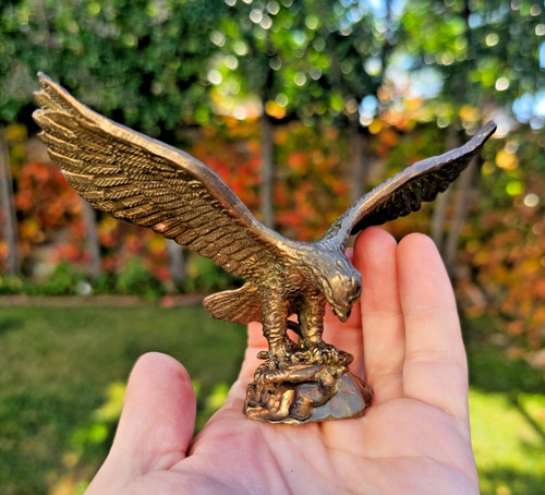 Bronze eagle eating - eagle,
