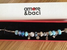 PRE OWNED AMORE & BACI STERLING SILVER BRACELETS IN BLUE COLOURED CHARMS