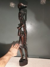 Large African wooden sculpture of a naked woman carrying a basket on her head