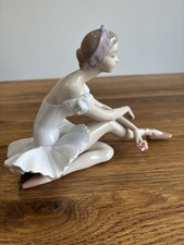 Lladro ballerina in sitting position - good condition, small chip on a petal