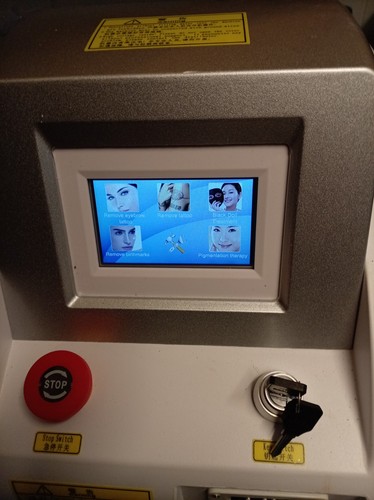 Corded laser tattoo removal - tattoo,
