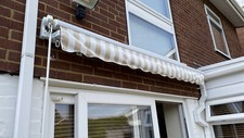 Primrose 2.5 metre manual retractable awning in mocha brown and white stripe