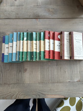 An assorted collection of 13 used Penguin books, orange green blue etc, vintage