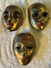 set of 3 brass wall masks. engraved and enameled. from the 70’s.