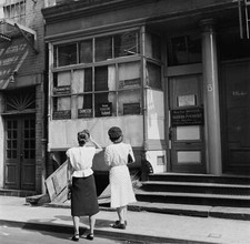 Two Women Stop To Read Signs