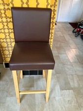 Brown wooden and vinyl tall bar style stool