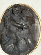 VICTORIAN CARVED BASALT CHERUB CUDDLING LAMB IN 9CT GOLD BROOCH