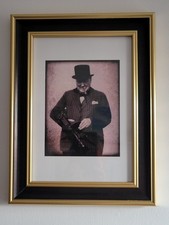Black and gold framed portrait