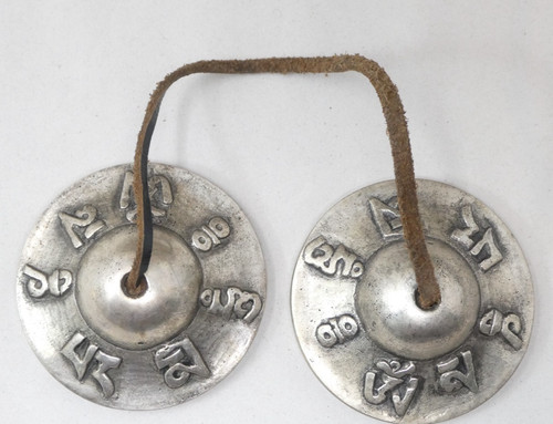 Tibetan tingsha cymbals raised - tingsha,