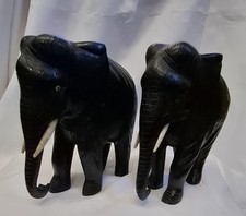 Pair Of Vintage Heavy Hand Carved Dark Wood Elephants. Tusks intact.