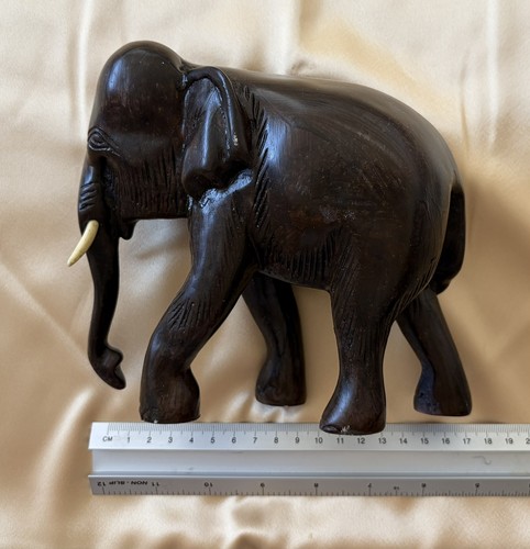 Dark brown elephant with tusks - brown,
