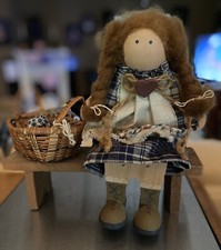 Wooden Doll Sitting on a Bench