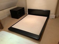 Low Japanese black king size bed frame with headboard.