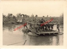 Soldiers crossing horses by
