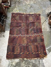 A vintage Afghan handmade wool rug / kilim with geometric pattern and fringes.
