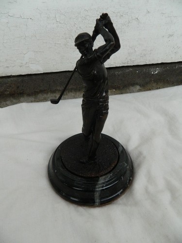 Bronze figure golfer on - of,
