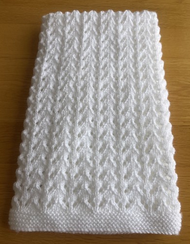 Hand knitted white baby - hand,