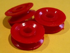 Three Meccano red plastic