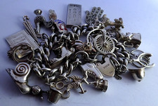 Vintage solid silver charm bracelet & numerous curious silver charms inc moving