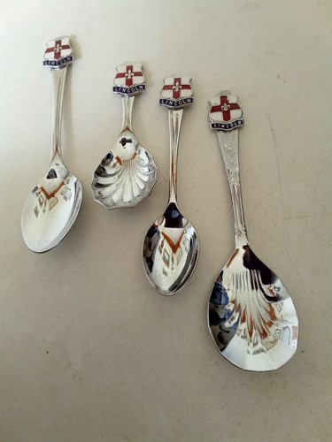Four plated spoons with