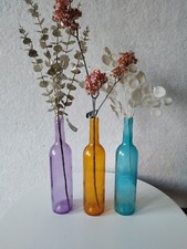 artificial flowers In Coloured  Glass Bottles