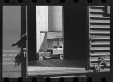 Truck unloading sacks of wheat