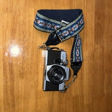 Praktica Super TL 1000 film camera with a decorative camera strap