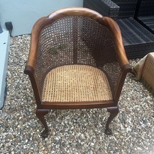 ANTIQUE BERGERE CHAIR ,carved ornate feet ,ratten back and seat  