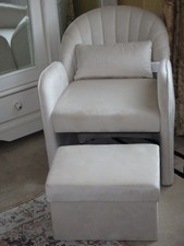 A modern cream velvet tub chair with footrest storage and lumbar pillow, unused.