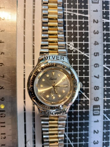 Gold and stainless steel watch - and,
