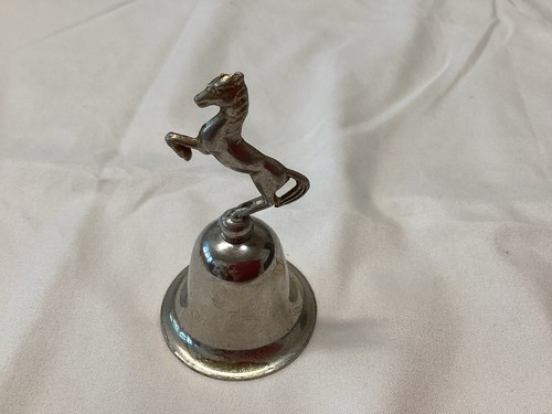 Bell with horse - on, top