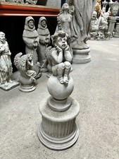 Cherub on ball with plinth