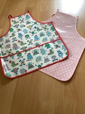 Ex Cath Kidston PVC oil cloth aprons - pink spot monsters
