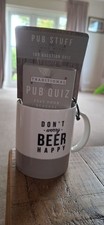 Unwanted Gift Bell & Curfew Mug & 100 Question Quiz. Don't Worry Beer Happy Mug