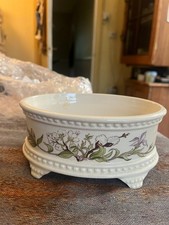 Royale Winton decorative planter with legs and floral embellishments. 