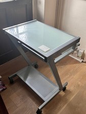 Modern computer table desk with tempered glass surface and sliding shelf  .