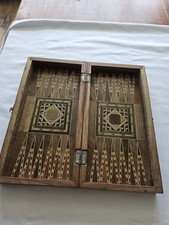 Backgammon-Chess-checkers board Inlaid with various woods and mother of pearl.