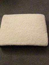 A Cushion To Raise The Height Of A Person On A Chair Or Settee 