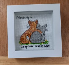 Completed cross stitch framed